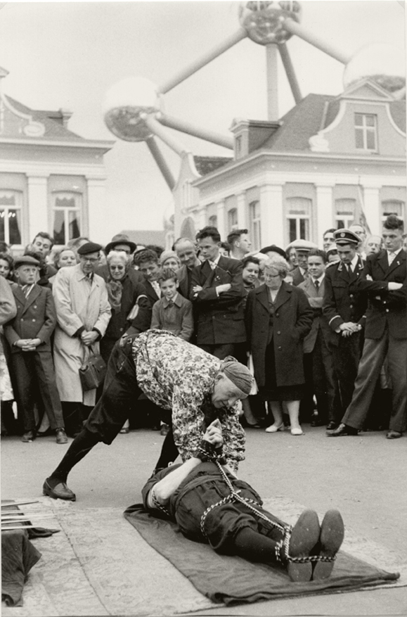 Henri Cartier-Bresson - Escape-Artist Performance in front of Atomium, Brussels World Fair Henri Cartier-Bresson - Escape-Artist Performance in front of Atomium, Brussels World Fair