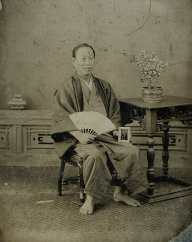 Anonymous - Japanese Man in Traditional Garb Holding Another Ambrotype of His Portrait in Western-Style Clothing Anonymous - Japanese Man in Traditional Garb Holding Another Ambrotype of His Portrait in Western-Style Clothing
